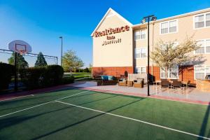 a tennis court in front of a building with a basketball hoop at Residence Inn Indianapolis Fishers in Fishers