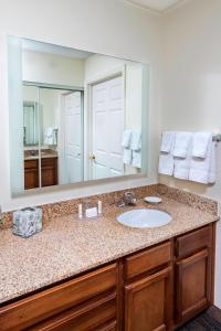 a bathroom with a sink and a large mirror at Residence Inn Huntsville in Huntsville