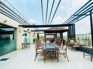 a patio with a table and chairs on a balcony at Grand Regent Hotel and Suites in Faisalabad