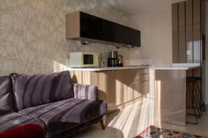 a living room with a couch and a microwave at Sea View Flat w Pool 1 min to Beach in Kusadasi in Kusadası