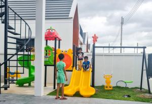 two children playing on a playground at child shill pool villa in Ban Wang Bot