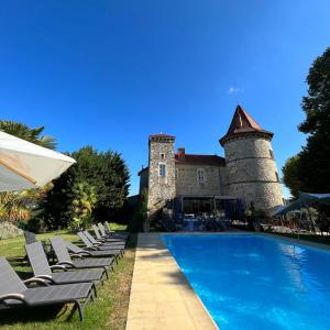 a resort with a swimming pool and a castle at Les Dépendances du Château Chapeau Cornu in Vignieu +32 photos