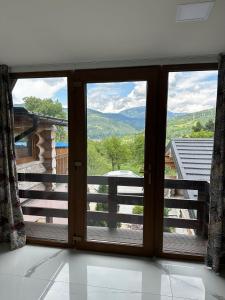 a sliding glass door with a view of the mountains at Cabana A in Borşa