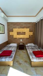 two beds in a room with two red sheets at Lidia Dahab Hotel and Restaurant in Dahab