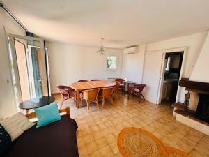 a living room with a wooden table and chairs at Escale Douceur d'Estérel in Saint-Raphaël