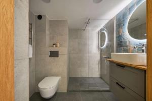 a bathroom with a toilet and a sink at Queen Barbora Central Lofts in Kaunas