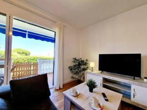 a living room with a large flat screen tv at Ground floor Apt in La Cala in Mijas Costa