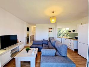 a living room with a blue couch and a table at Ground floor Apt in La Cala in Mijas Costa