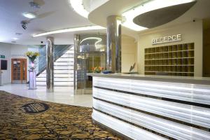 a store lobby with a reception counter and stairs at Wellness Hotel Eroplán in Rožnov pod Radhoštěm