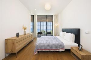 a bedroom with a bed and a large window at Barbaros Reserve Bodrum Residences Managed by Kempinski in Bodrum City