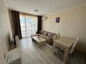 a living room with a couch and a table at SEA-VIEW APARTMENT in VILLA SARDINIA SVETI VLAS in Sveti Vlas