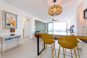 a living room with a table and chairs and a window at Los acantilados in Almería