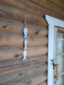 a pair of birdhouses hanging on a wooden wall at Rantamökki Naava in Hämeenlinna