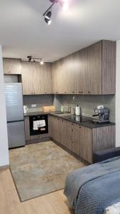 a kitchen with wooden cabinets and a counter top at Apartament "Cztery Pory Roku" in Świdnik