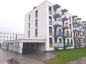 a white building with balconies on the side of it at Apartament "Cztery Pory Roku" in Świdnik