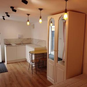 a kitchen with a table and a counter top at Self Contained, Double Bed Studio, private kitchen, private Bath, Walking distance to Harry Potter in Leavesden Green