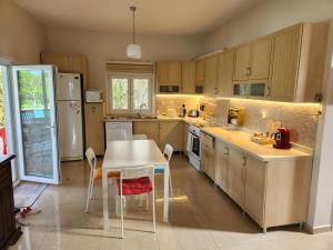 a kitchen with a table and a table and chairs at Villa Piano in Gebze