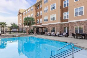 a swimming pool in front of a building at Residence Inn by Marriott Houston Katy Mills in Katy