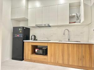 a kitchen with a counter with a microwave and a refrigerator at Pan House in Hanoi