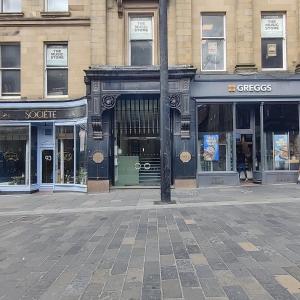 a street with store fronts on a city street at The Monument in Newcastle upon Tyne