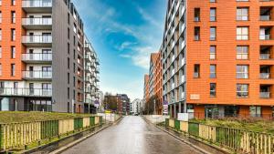 an empty street in a city with tall buildings at Maya's Flats & Resorts 34 - Chmielna 73 in Gdańsk