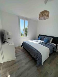 a bedroom with a bed and a television in it at Completely renovated villa in Cap d'Ail