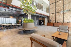 a large room with a large pot with plants in it at City Express Plus by Marriott Mexicali in Mexicali