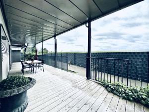 a patio with a table and chairs on a deck at BUSINESS APARTMENT in Deitingen Tiny House ZIMMERzuVERMIETEN in Deitingen