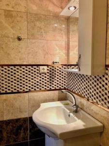 a bathroom with a sink and a mirror at Yalova Halic apartment in Yalova