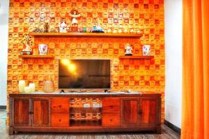 sala de estar con TV en una pared de ladrillo en Melia's House Tagaytay - Nature Home for Rent, en Tagaytay