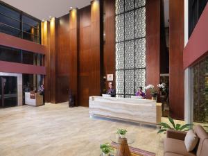 a lobby with a reception desk in a building at Swiss-Belinn Timika in Timika