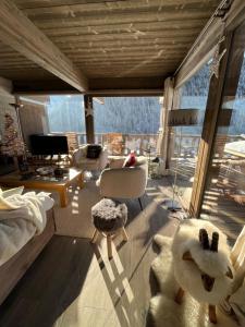 a living room filled with furniture and a large window at Chalet Alpaga 3 classé 4 étoiles in Châtel