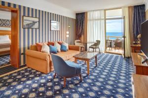 - un salon avec un canapé et une chambre avec vue dans l'établissement Remisens Hotel METROPOL, à Portorož