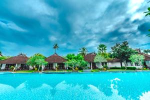 a swimming pool in front of a villa at Rhythm Kumarakom in Kumarakom