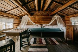 a bedroom with a bed and a table in a cabin at Arctic Dome Namdalen in Hoylandet