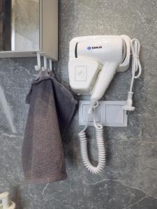 a hair dryer on a wall in a bathroom at Irisapart A65 in Warsaw
