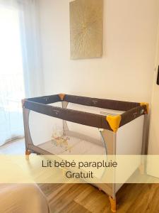 a bed frame in a bedroom with a picture on the wall at Le Mayda - Parking Privé Gratuit in Marseille