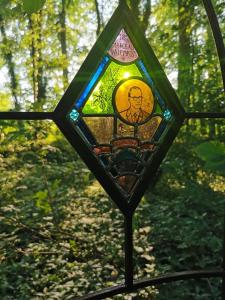 a stained glass window of a path in the woods at Manoir Marceau in Vieil-Hesdin