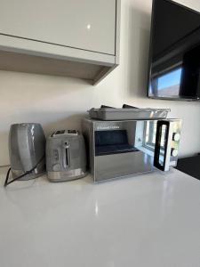 a toaster oven sitting on a counter in a kitchen at Studio Apartment Great Location in Swadlincote