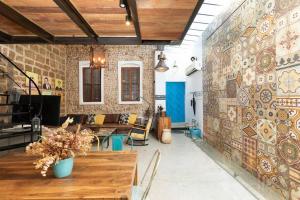 a living room with a wall covered in tiles at Luxury Villa by the Beach in Neve Tzedek's Heart! in Tel Aviv