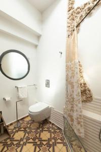 a bathroom with a toilet and a mirror at Luxury Villa by the Beach in Neve Tzedek's Heart! in Tel Aviv