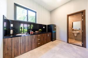 a bathroom with a sink and a toilet and a window at Emerald Garden Retreat in Phú Quốc