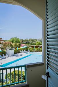 a view of a swimming pool from a balcony at ISA-Residence with swimming-pool at only 450 meters from the beach in Mazzanta