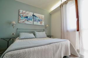 a bedroom with a bed and two posters on the wall at ISA-Residence with swimming-pool at only 450 meters from the beach in Mazzanta