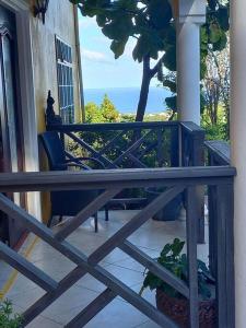 a porch with a table and chairs on a balcony at Bellevue hideaway in Gros Islet