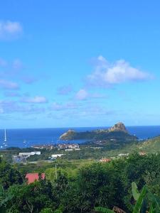 a view of the ocean and a town with mountains at Bellevue hideaway in Gros Islet