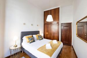una piccola camera con letto, tavolo e lampada di Wine Apartments a Porto