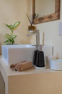 a bathroom counter with a sink and a towel at NETS Cowork & Colive in Ahangama