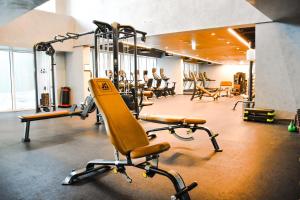 a gym with cardio equipment in a large room at Voyage One Bedroom In Mayan in Abu Dhabi