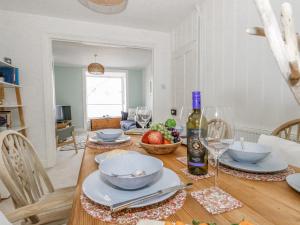a dining room table with bowls of food and a bottle of wine at Lyme View in Portland